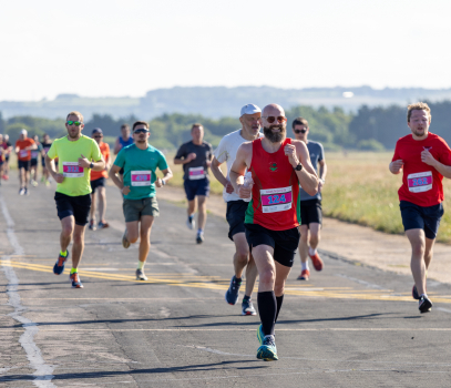 A group of people running on a runway