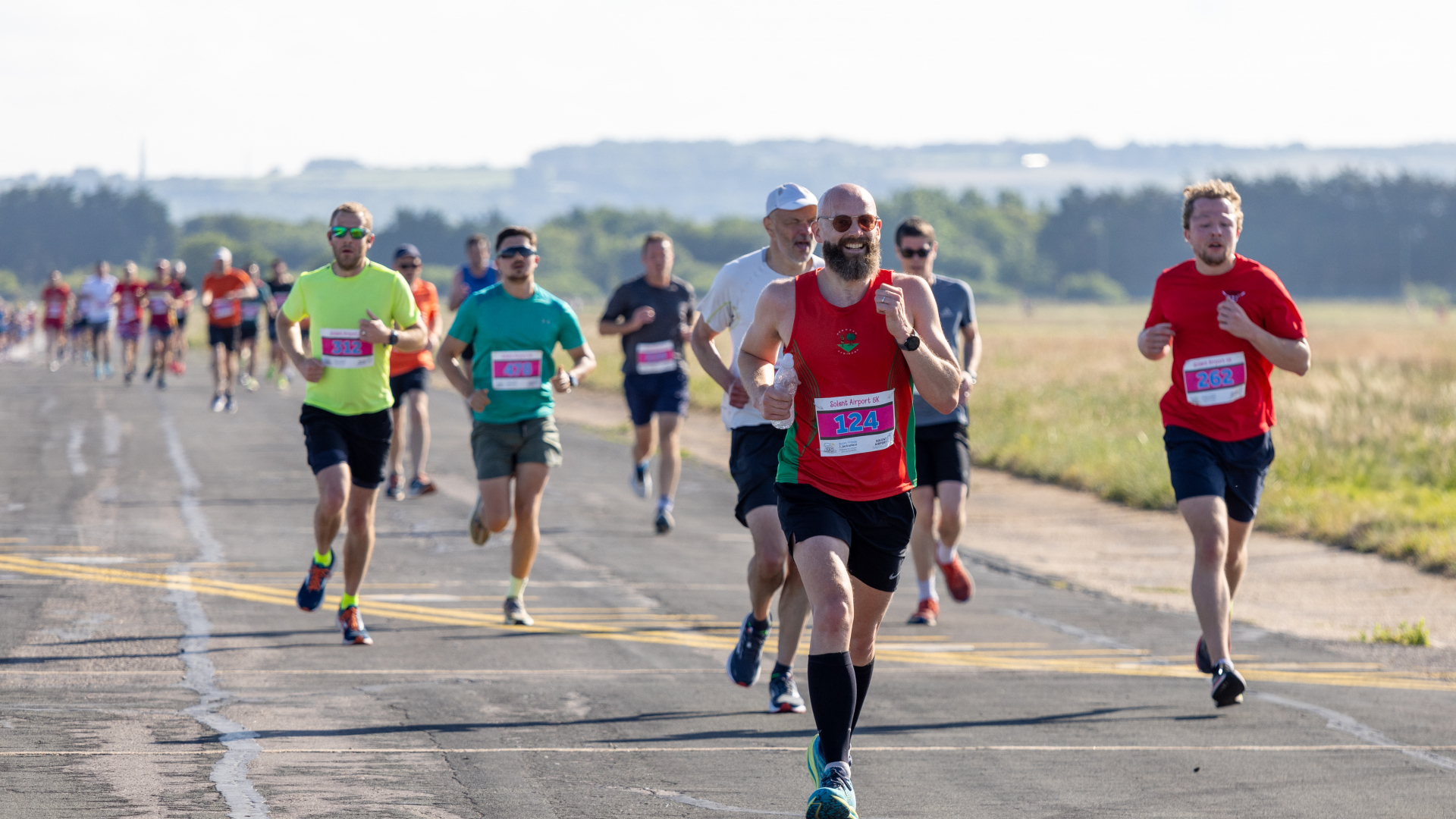 A group of people running on a runway