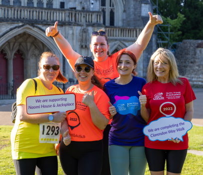 A groups of ladies smiling in front of Winchester Cathedral