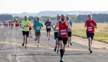 A group of people running on a runway