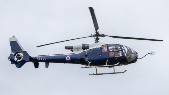 Navy blue helicopter in air with Father Christmas waving