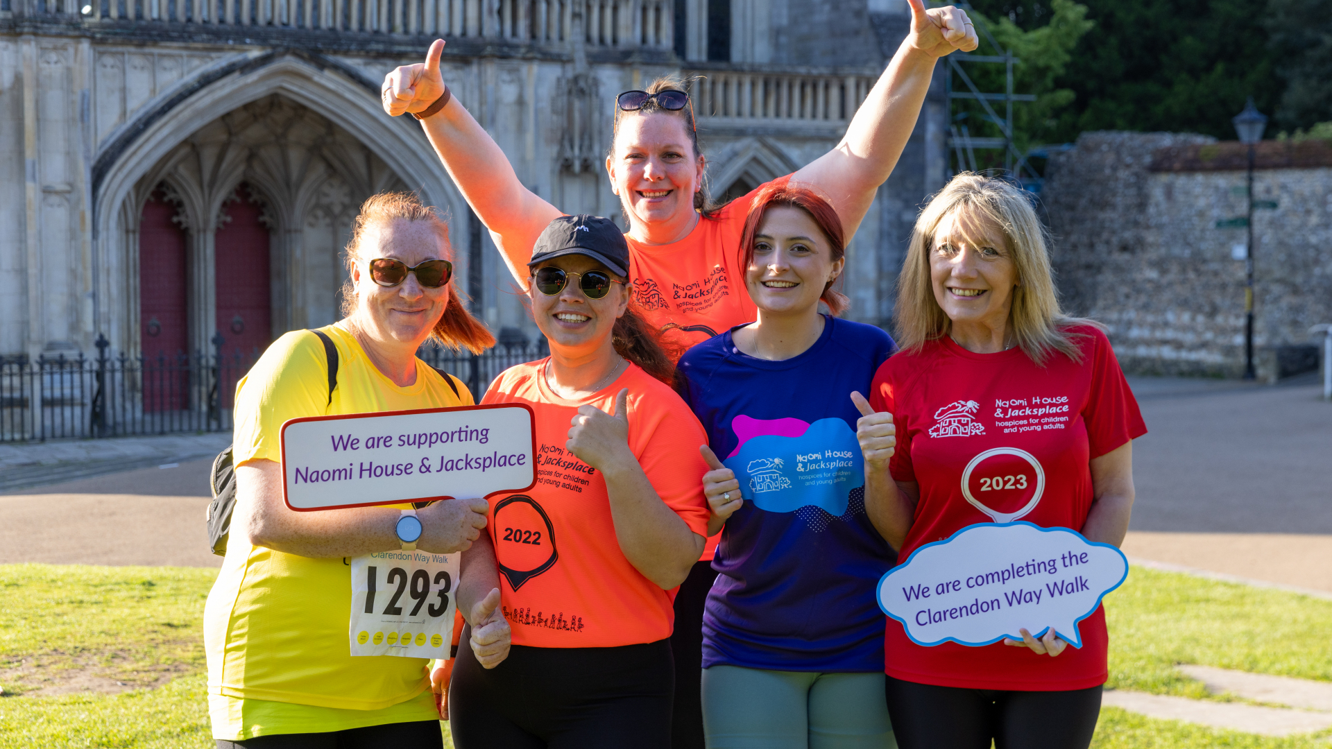 A groups of ladies smiling in front of Winchester Cathedral