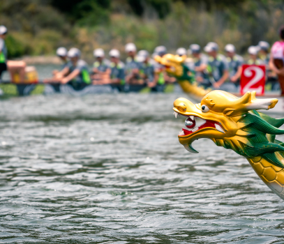 head of a dragon boat with boats racing in the distance