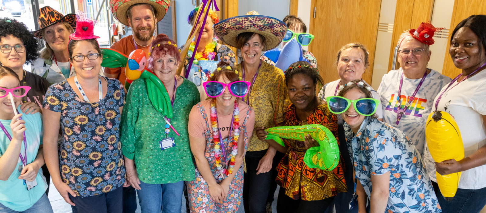Naomi House and Jacksplace staff smiling together in fun outfits
